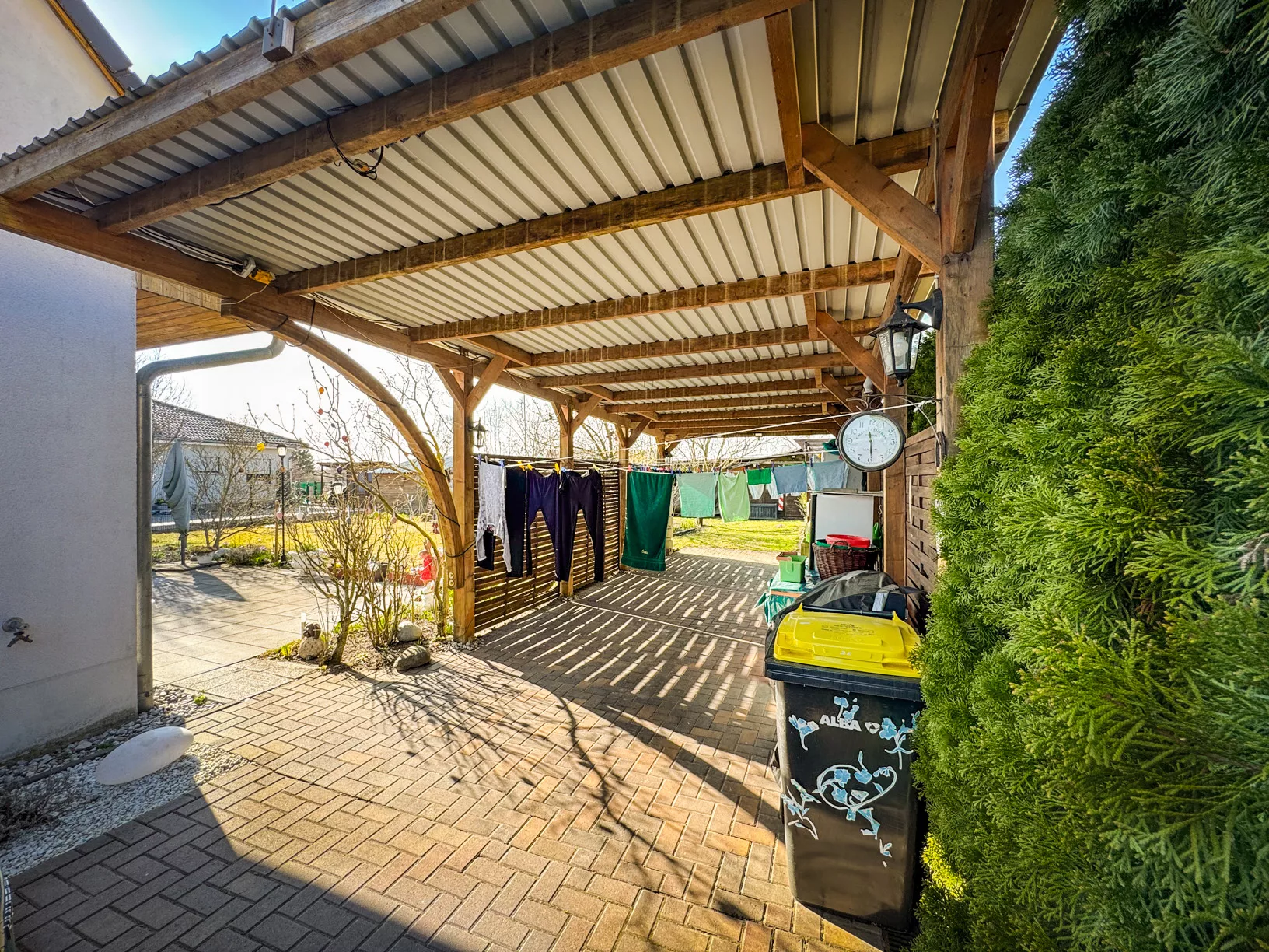 Langer Carport mit Platz für zwei hintereinander parkende Fahrzeuge am Einfamilienhaus in Berlin-Falkenberg
